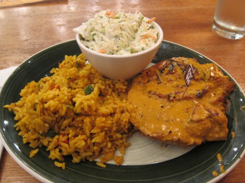 Nando's peri-peri chicken with extra spicy sauce, rice, and cole slaw in Washington, DC.